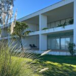 Nuno Graça Moura's 24 Row Houses at Bom Sucesso Resort showcasing a modern design with integrated garden landscaping, ample daylighting, and shaded outdoor areas.