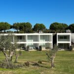 Nuno Graça Moura's 24 Row Houses at Bom Sucesso Resort showcasing a modern estate design with landscaped gardens, a central courtyard, and villa-style architecture.