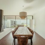Nuno Graça Moura's 8 Villas at Bom Sucesso Resort showcasing modern interior design with wood flooring, contemporary furniture, and elegant lighting fixtures.