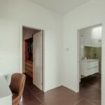 Nuno Graça Moura's 8 Villas at Bom Sucesso Resort showcasing modern interior design with wooden flooring, sleek walls, and ambient lighting.