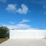 Nuno Graça Moura's 8 Villas at Bom Sucesso Resort showcasing a modern design with concrete structures, ample daylighting, and distinct shadows cast across the land lot during daytime.
