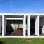 Nuno Graça Moura's Bar Code 1 - 30 Row Houses at Bom Sucesso Resort showcasing a modern design with concrete structures, ample daylighting, and outdoor shaded areas.