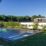 Nuno Graça Moura's Bar Code 2 - 12 Row Houses at Bom Sucesso Resort showcasing a modern design with composite materials, a swimming pool, landscaped gardens, and eco-friendly features.