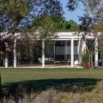 Nuno Graça Moura's Bar Code 2 - 12 Row Houses at Bom Sucesso Resort showcasing a modern design with columns, landscaped gardens, and outdoor structures.