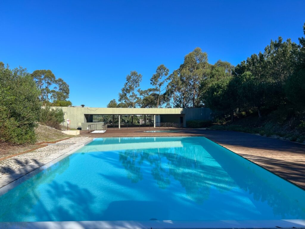 Nuno Graça Moura's Pool Bar at Bom Sucesso Resort showcasing a modern concrete structure with elements resembling an overpass and concrete bridge.