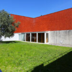 Nuno Portas and Joaquim Oliveira's "Bookstore, Reading Room and Multimedia Centre, University of Aveiro" showcasing a brick exterior with daylighting features and a surrounding lawn.
