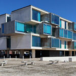RVdM Arquitectos' ORIZZONT Residential Building showcasing a modern design with prominent balconies, effective daylighting, and strategic shade elements.