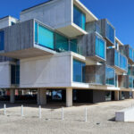 RVdM Arquitectos' ORIZZONT Residential Building showcasing a Brutalist architecture style with composite materials, featuring prominent balconies and strategic daylighting elements.