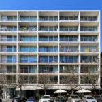 Adalberto Dias’s Casas Brancas high-rise condominium featuring a sleek glass façade and modern apartment design with clean lines and spacious balconies.