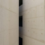 Adalberto Dias’s Casas Brancas showcasing symmetrical design with grey concrete walls, composite material flooring, and tiled surfaces.