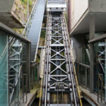 Adalberto Dias’s Funicular dos Guindais showcasing a steel and iron funicular railway with composite material stairs, metal handrails, glass panels, and visible engineering elements.