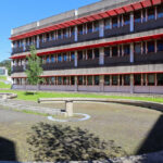 Alexandre Alves Costa and Sérgio Fernandez’s Escola de Ciências Sociais at Universidade do Minho showcasing a brutalist architecture style with exposed concrete, a spacious courtyard, shaded public spaces, and integrated urban design elements on the campus.