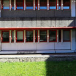 Alexandre Alves Costa and Sérgio Fernandez’s Escola de Ciências Sociais at Universidade do Minho showcasing a brutalist concrete structure with composite material elements, prominent shading features, and strategic daylighting.
