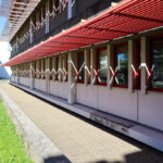 Alexandre Alves Costa and Sérgio Fernandez’s design of the Escola de Ciências Sociais at Universidade do Minho showcasing a composite material façade, shaded walkways, and modern campus headquarters elements.