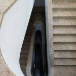 Álvaro Siza Vieira's Casa Ferreira da Costa / Casa Miranda dos Santos showcasing a modern design with concrete and composite materials, featuring prominent stairs and daylighting elements casting shadows.