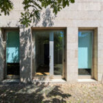 Álvaro Siza Vieira’s Centro de Estudos Camilianos showcasing a minimalist concrete structure with plastered composite walls and strategically placed openings for natural daylighting.