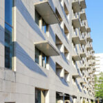 Álvaro Siza Vieira and António Madureira’s Edifício de Habitação da Boavista showcasing a high-rise concrete apartment building with a modernist façade and prominent vertical lines.