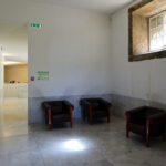 Álvaro Siza Vieira and Eduardo Souto de Moura’s Museum of International Contemporary Sculpture showcasing clean tile flooring, plaster ceiling, and minimalist interior design elements.