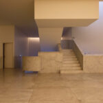 Museum of International Contemporary Sculpture designed by Álvaro Siza Vieira and Eduardo Souto de Moura showcasing interior architecture with concrete walls, composite tile flooring, and a minimalist ceiling design.