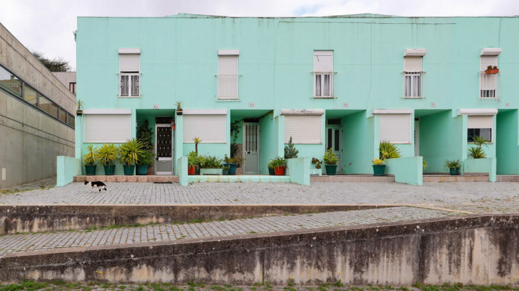 Álvaro Siza Vieira’s Habitação Social Bairro São Víctor - SAAL showcasing a concrete apartment complex with composite material elements, painted surfaces, and urban design features optimized for daylighting.