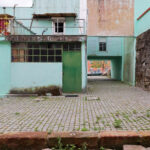 Álvaro Siza Vieira’s Habitação Social Bairro São Víctor - SAAL showcasing a residential neighborhood with concrete walls, composite materials, iron doors, and green elements integrated into the architecture.