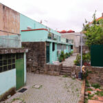 Álvaro Siza Vieira’s Habitação Social Bairro São Víctor - SAAL showcasing a residential area with concrete and brick walls, sloped urban design, and composite materials in a suburban human settlement.
