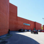 Álvaro Siza Vieira’s Pavilhão Multiusos de Gondomar showcasing a multi-material façade combining brickwork, concrete, and composite materials with a modern, angular design.