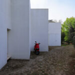 Álvaro Siza Vieira’s Piscina da Quinta da Conceição showcasing a minimalist concrete structure with plaster finishes, composite materials, and strategic daylighting creating dynamic shadows.