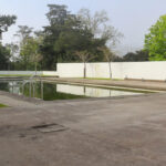 Álvaro Siza Vieira’s Piscina da Quinta da Conceição showcasing a minimalist swimming pool with a reflective water surface, composite material edges, and a tranquil pond-like design.