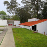 Álvaro Siza Vieira’s Piscina da Quinta da Conceição showcasing a minimalist concrete structure with composite materials, plaster finishes, integrated shading elements, and landscaped lawn surroundings.