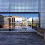 Casa Sacerdotal de São Martinho de Dume by André and António Fontes showcasing a composite material and concrete structure with steel and iron elements, featuring a glass façade that enhances daylighting and engineered shading assemblies.