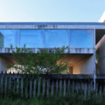 Projecto Homem by André and António Fontes showcasing a brutalist concrete structure with composite material elements and large daylighting openings.
