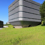 António Fontes’ Instituto para a Bio-Sustentabilidade at Universidade do Minho showcases a high-rise brutalist commercial building with a composite material façade, featuring bold geometric forms and large vertical windows under daylight.