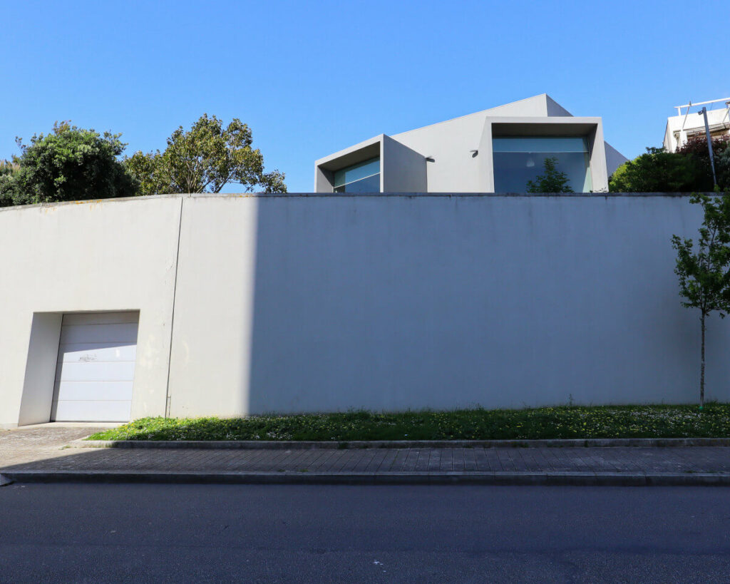 Eduardo Souto de Moura’s Casa do Cinema Manoel de Oliveira showcasing a modern interior with composite material walls, extensive glass panels allowing natural daylighting, and transparent structural elements emphasizing engineering and scientific design principles.