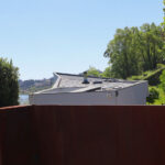 Eduardo Souto de Moura’s Casa em Oliveira do Douro showcasing a concrete structure with composite materials, sloped roof, and strategic daylighting creating dynamic shadows.