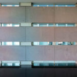 Eduardo Souto de Moura’s Edifício Burgo showcasing a modern glass façade designed for optimal daylighting with clean, minimalist structural elements.