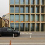 Eduardo Souto de Moura’s Edifício de Habitação e Comércio showcasing a brutalist commercial building with a concrete façade and geometric structural elements.