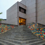 Eduardo Souto de Moura’s Fórum da Maia showcasing a concrete structure with composite material walls and a prominent staircase.