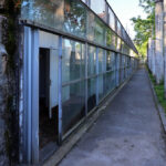 Eduardo Souto de Moura’s Mercado Municipal de Braga reconversion featuring concrete and metal composite materials, iron walkways, and daylighting elements in an alley setting.