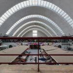 Fortunato Cabral and Cunha Leão’s Mercado de Matosinhos showcasing a commercial retail building with a spacious hall, extensive daylighting, and a modern glass façade designed for customer engagement and shade.