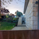 House 1 to 6 by Jean Pierre Porcher, Joaquim Oliveira, and Albino Freitas showcasing modern architecture with composite material walls, concrete elements, stone walls, landscaped gardens, and shaded walkways.