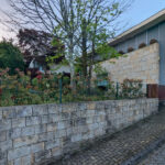 House 1 to 6 by Jean Pierre Porcher, Joaquim Oliveira, and Albino Freitas showcasing modern architecture with composite material walls, stone and brickwork, sloped concrete driveways, and varied building materials.