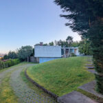 Loteamento D. Antónia Amorim by Jean Pierre Porcher, Margarida Oliveir, and Albino Freitas showcasing landscaped gardens with conifers, evergreen firs, hedges, and shrubbery surrounding residential land lots.
