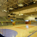Jorge Nuno Monteiro’s Pavilhão Desportivo Municipal de Santo Tirso showcasing a modern sports venue with an indoor basketball court, visible basketball hoops, netting, and a spacious arena hall designed for various indoor games and sports.