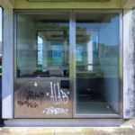 Jorge Nuno Monteiro’s Pavilhão Desportivo Municipal de Santo Tirso showcasing a composite material structure with extensive glass façades, concrete elements, and features designed for daylighting and shade with transparent home door assemblies.