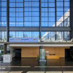 OPERA | Design Matters' Escola de Medicina, Universidade do Minho, showcasing a modern commercial building with a glass and composite material façade, metal structural elements, and extensive daylighting features.