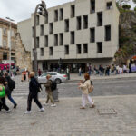 Pedra Líquida’s São Bento Residences showcasing a modern concrete façade with integrated urban design elements and pedestrian-friendly town square features.