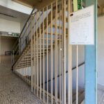 Ricardo Vieira de Melo and Eduardo Rebelo’s Complexo Pedagógico II at Universidade do Minho showcasing a modern architectural design with wooden walls, metal handrails, composite material flooring, and a prominent staircase assembly.