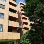 Unknown Architect’s Apartment Building Rua de João Paulo Freire showcasing a high-rise residential structure with a brutalist concrete façade, multiple balconies, and integrated urban landscaping.