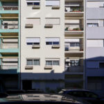 Colorful high-rise apartment buildings on Rua António José da Costa featuring balconies, concrete and composite materials, showcasing vibrant urban design and effective daylighting.